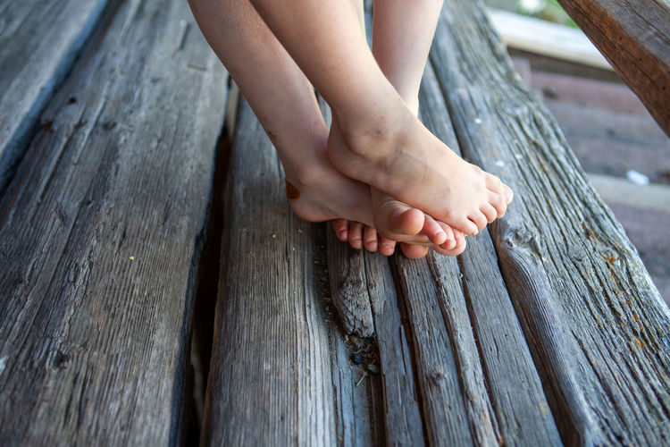 Leg's of girls on wooden bench