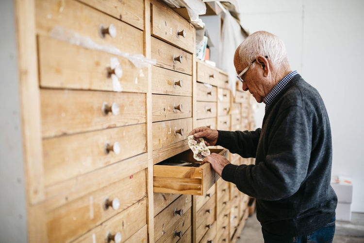 Senior man looking for decals for ceramics
