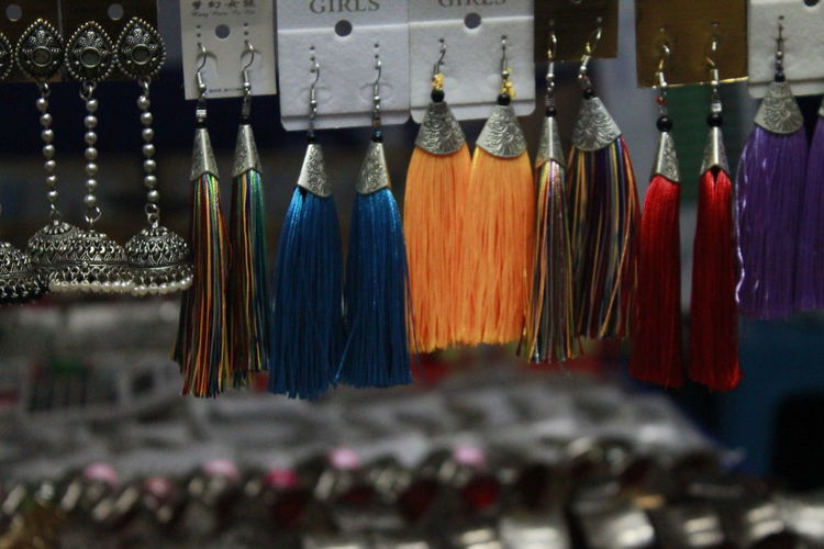 Close-up of clothes hanging in market for sale