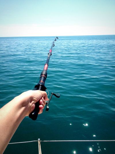 Close-up of hand holding fishing rod
