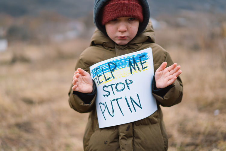 War of russia against ukraine. crying boy asks to stop the war in ukraine.