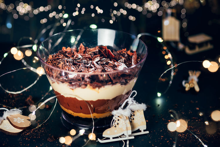 Pot of irresistible layered billionaires dessert made from mousse, belgian chocolate sauce