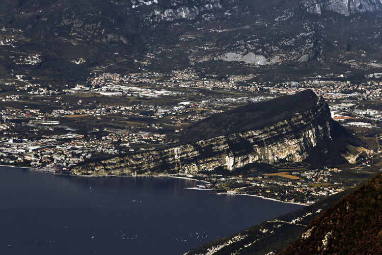 Arco di trento rocky fortress over garda lake aerial panorama, italy