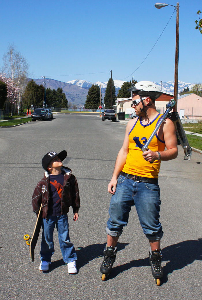 Full length of father and son at street on sunny day