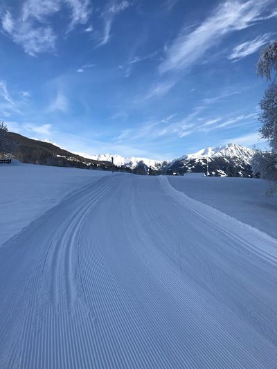Snow covered landscape against sky