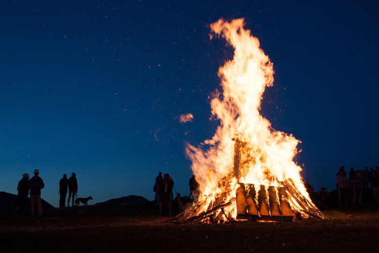 Panoramic view of bonfire against sky at night