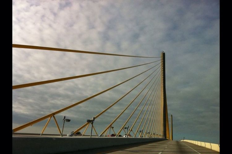 Low angle view of bridge against cloudy sky
