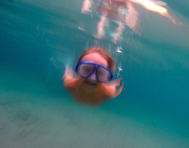 Close up of young man swimming in aquarium
