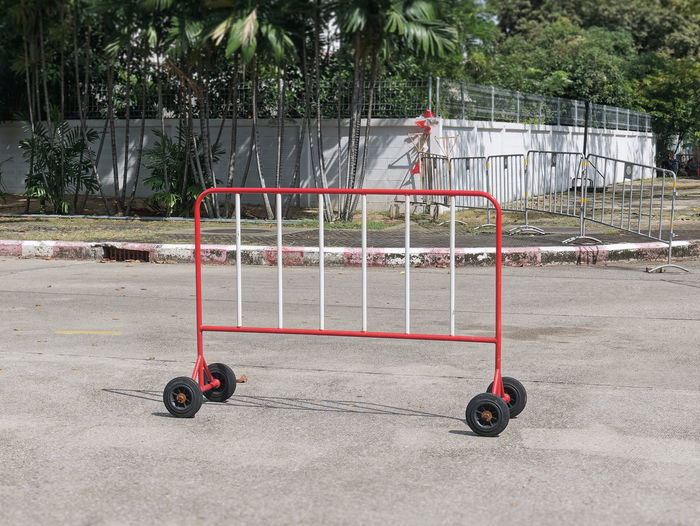 Red movable fence with wheels on the road