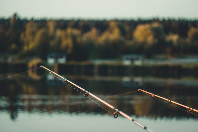 Close-up of fishing rod on lake