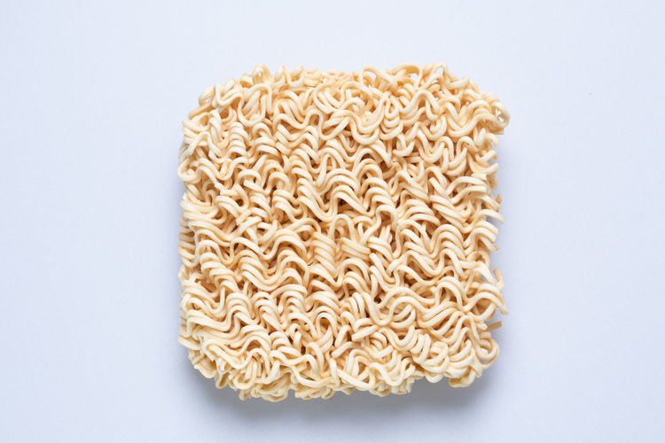 Directly above shot of pasta against white background