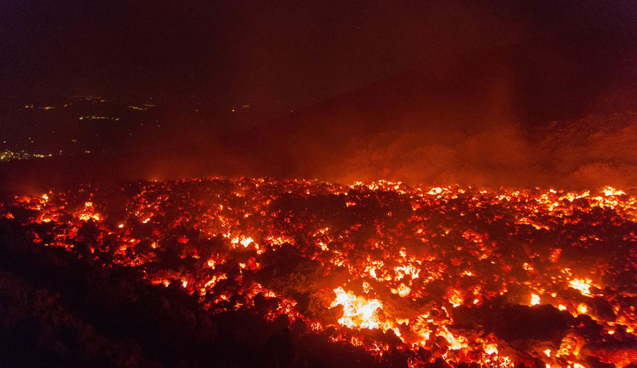 Lava flow on during eruption of etna volcano in sicily