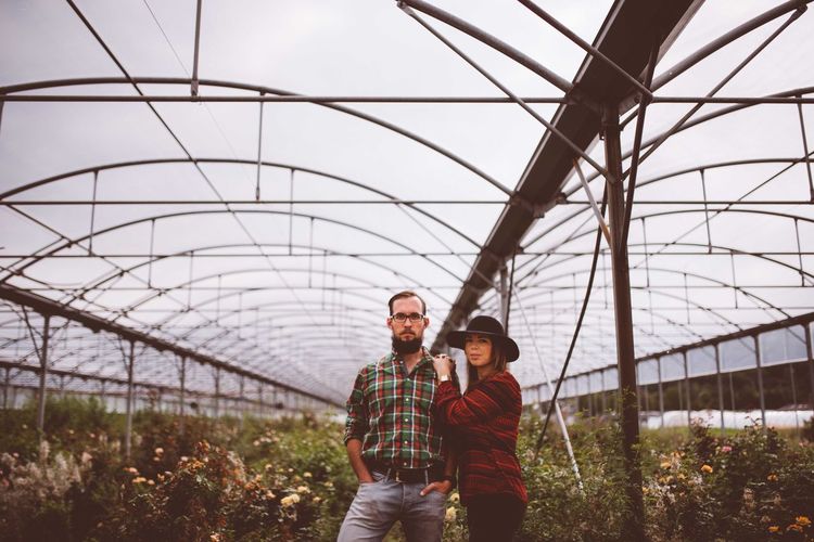 Portrait of couple standing in greenhouse