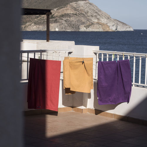 Clothes drying on railing against sky
