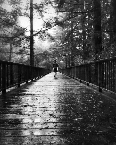Man walking on footbridge