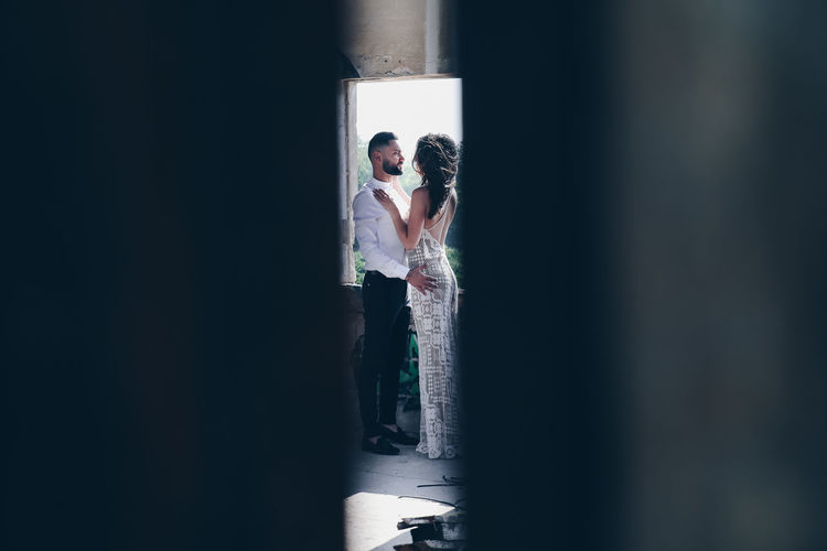 Couple standing against wall