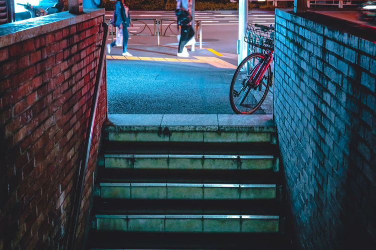 Full length of man cycling on street against wall