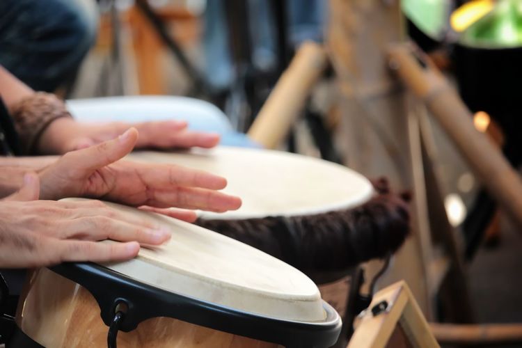 Cropped hands playing bongos