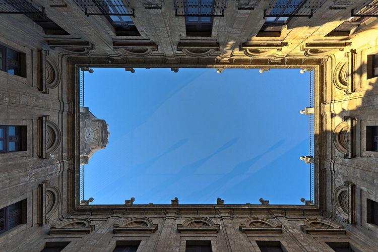 A courtyard in the royal tobacco factory of seville photographed from below