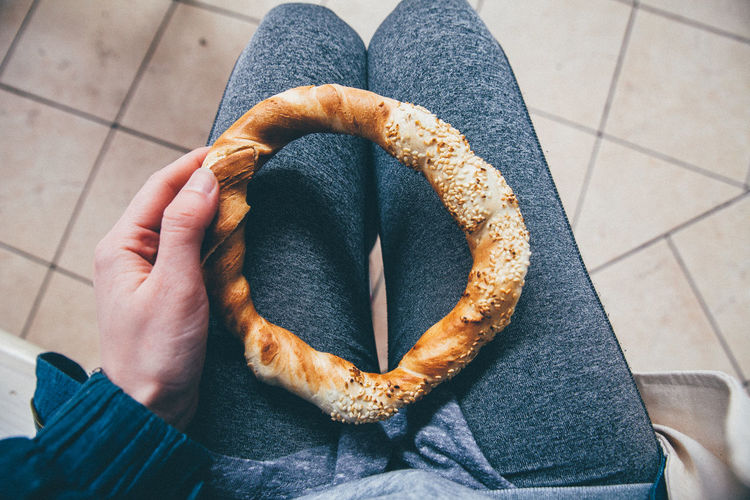 Mid section of a woman holding pretzel