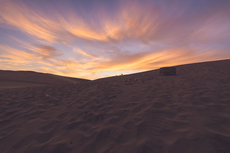 Water storage tanks on sand in desert