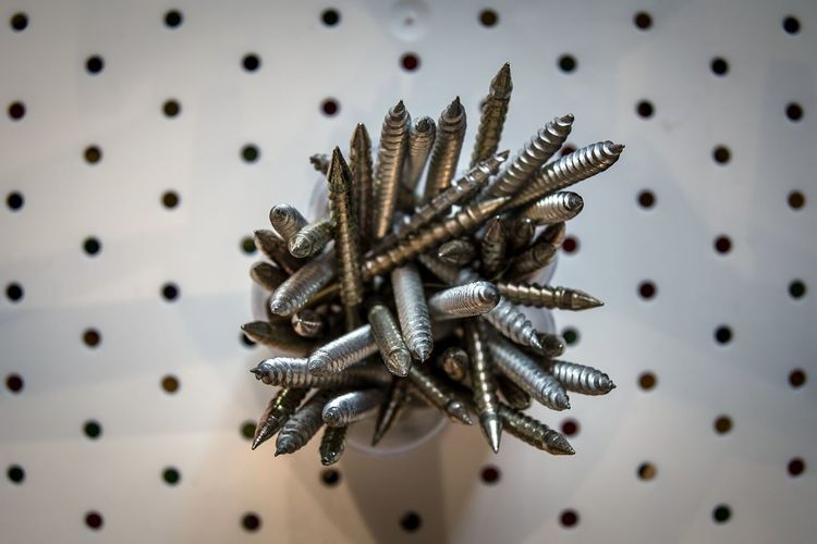 High angle view of nails in container on table