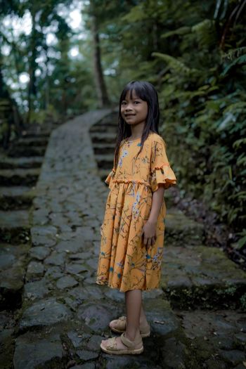 An asian little girl is about to climb situ gunung hill