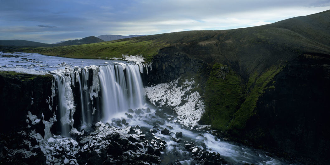 Unnamed half frozen waterfall in the icelandic highlands