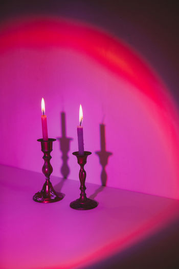 close-up of illuminated candles in temple