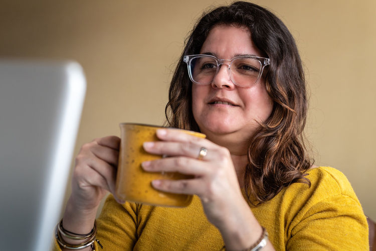 Portrait of woman holding mobile phone