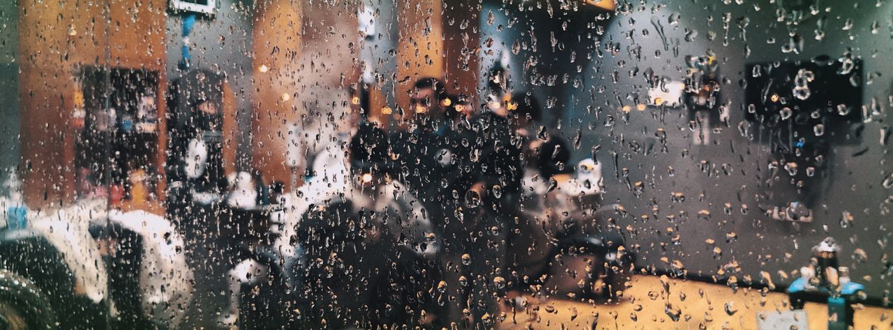 Group of people on wet glass window in rainy season