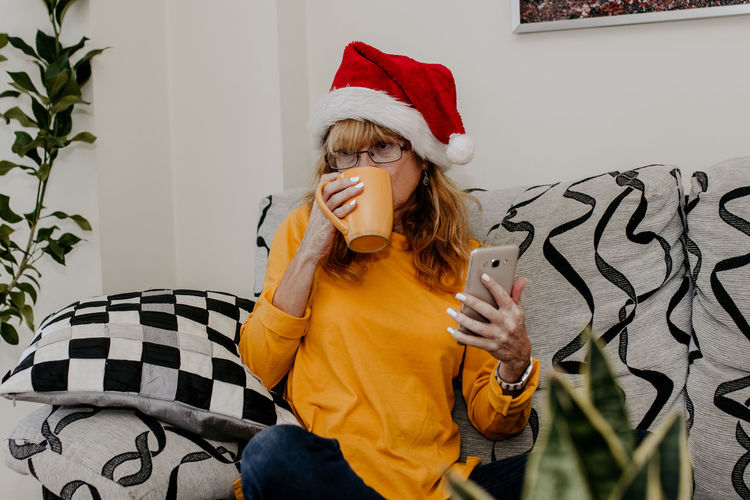 Portrait of young woman drinking coffee at home