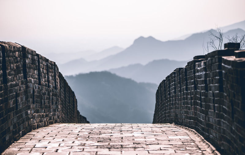 View of brick wall against mountain range