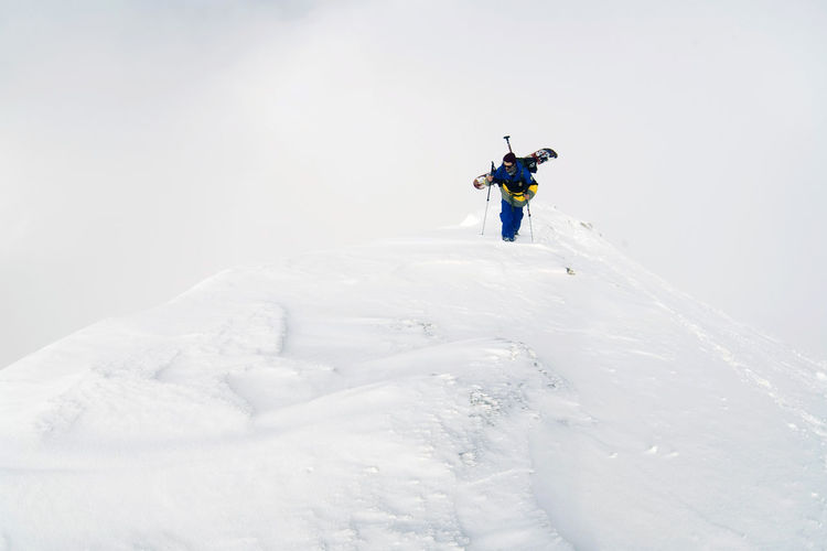 Man skiing on snow covered field