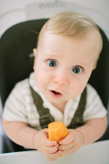 Baby making a funny expression as he tries a new food