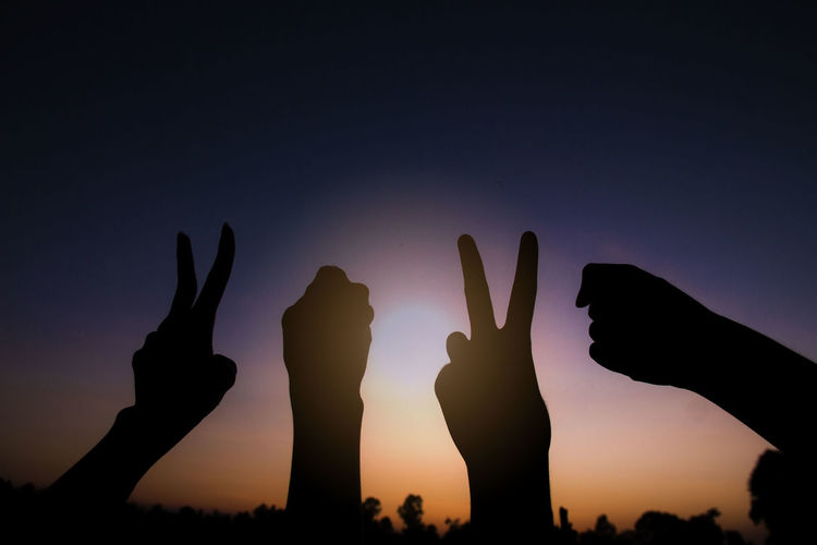 Silhouette of hands gesture v sign and fist power for victory/peace. success and winner in 2020.