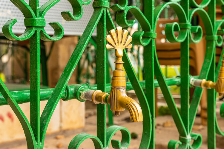 Close-up faucet on metal grate