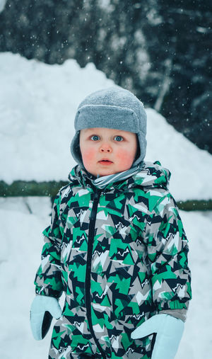 Portrait of cute boy in snow