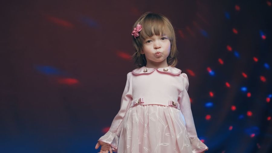 Portrait of young woman standing on stage