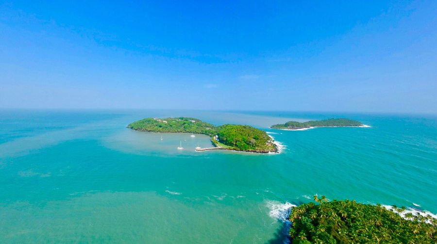 High angle view of bay against blue sky