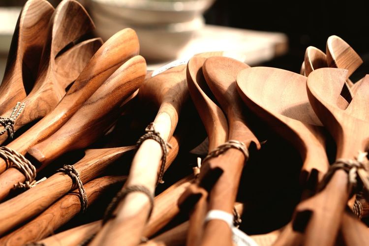 Close-up of tied wooden spoons at market stall