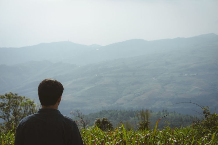 Rear view of man looking at mountains