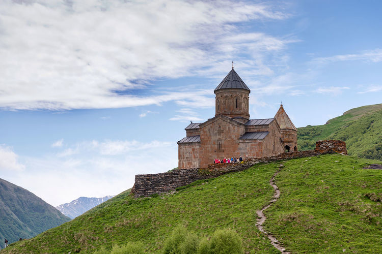 Low angle view of historic church on mountain against sky