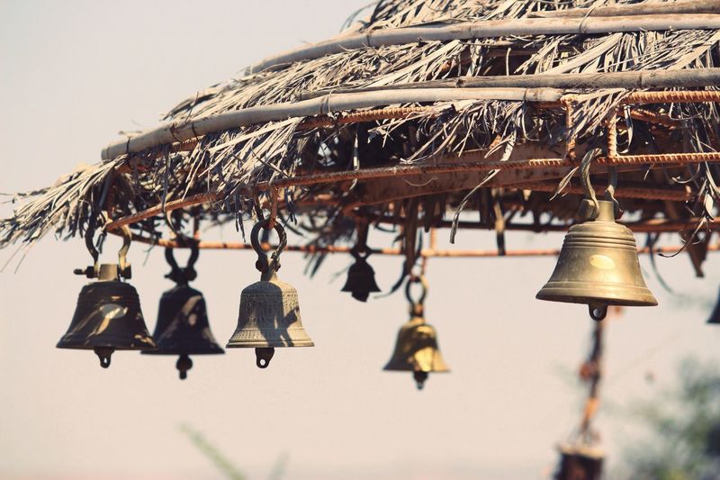 Close-up of bells hanging outdoors