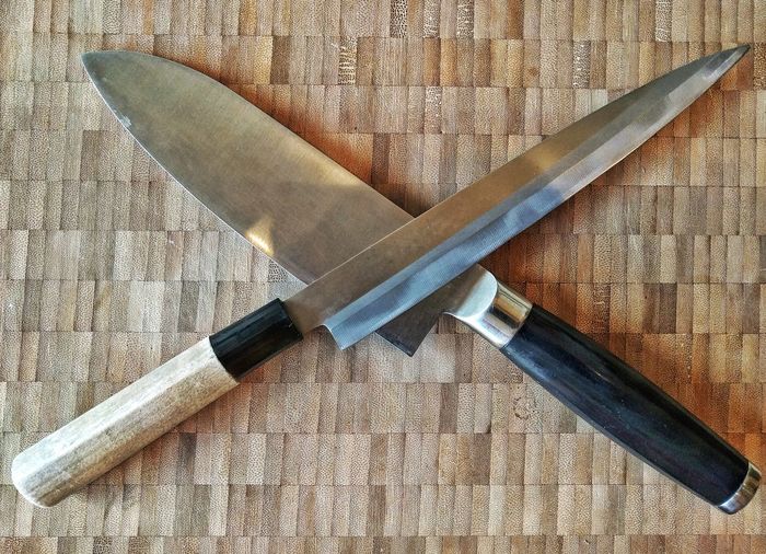 High angle view of knives on mat