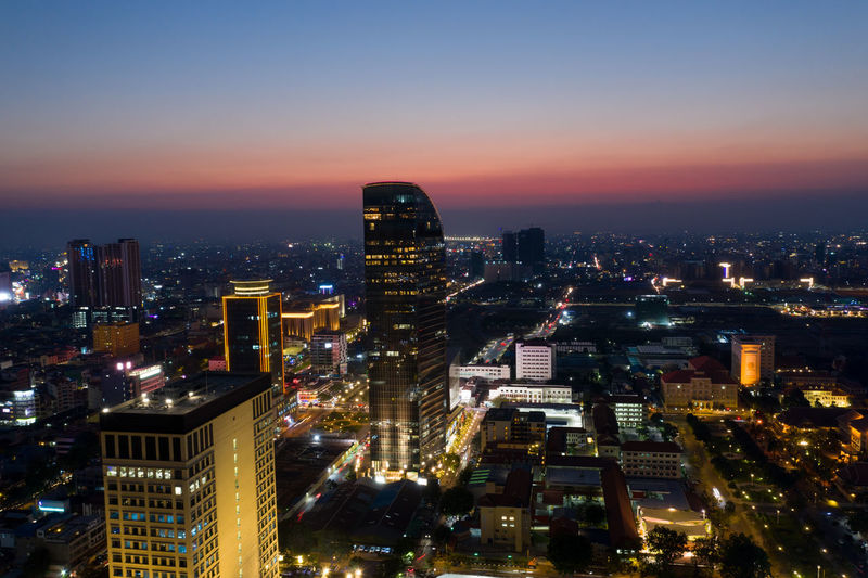 High angle view of illuminated buildings against sky at night