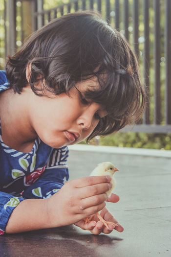 Portrait of cute boy holding girl