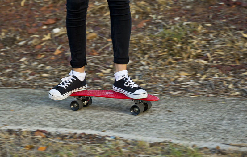 Low section of teenager on skateboard