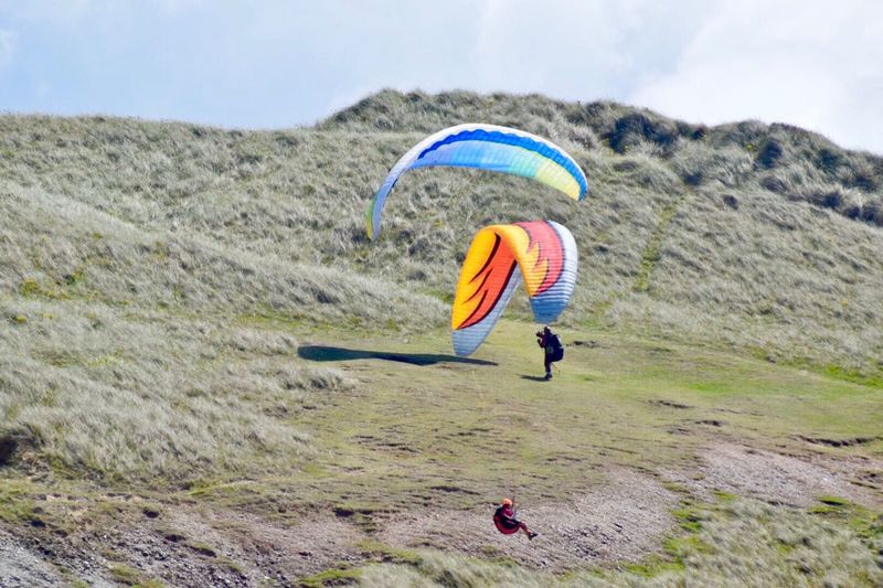 People paragliding on mountain
