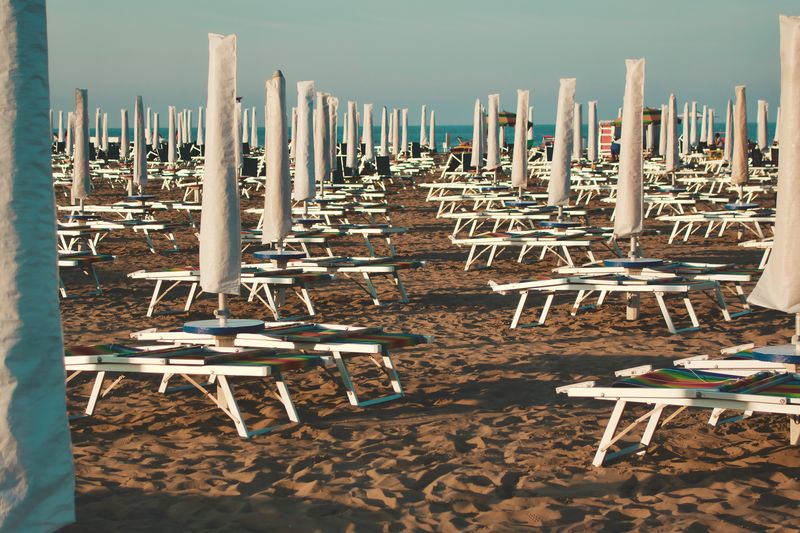 Chairs at beach against sky